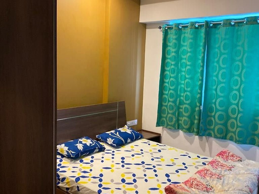 Cosy second bedroom with colourful curtains